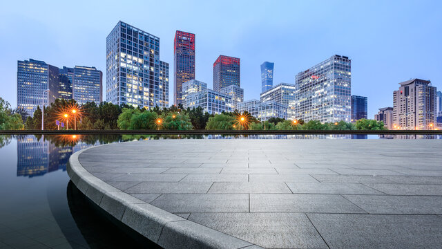 Panoramic skyline and modern commercial office buildings with empty circular square in Beijing, China.