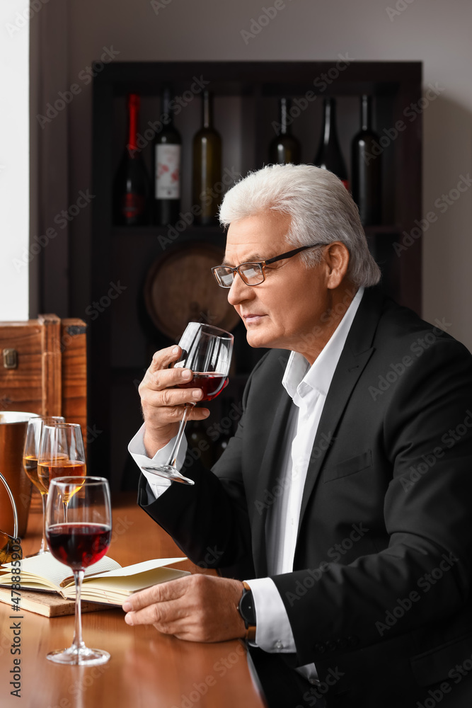 Mature sommelier tasting types of wine