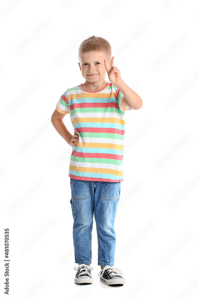 可爱的小男孩穿着条纹t恤，在白色背景下展示胜利手势