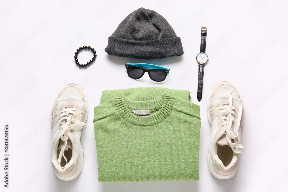 Male sweater, accessories and shoes on light background