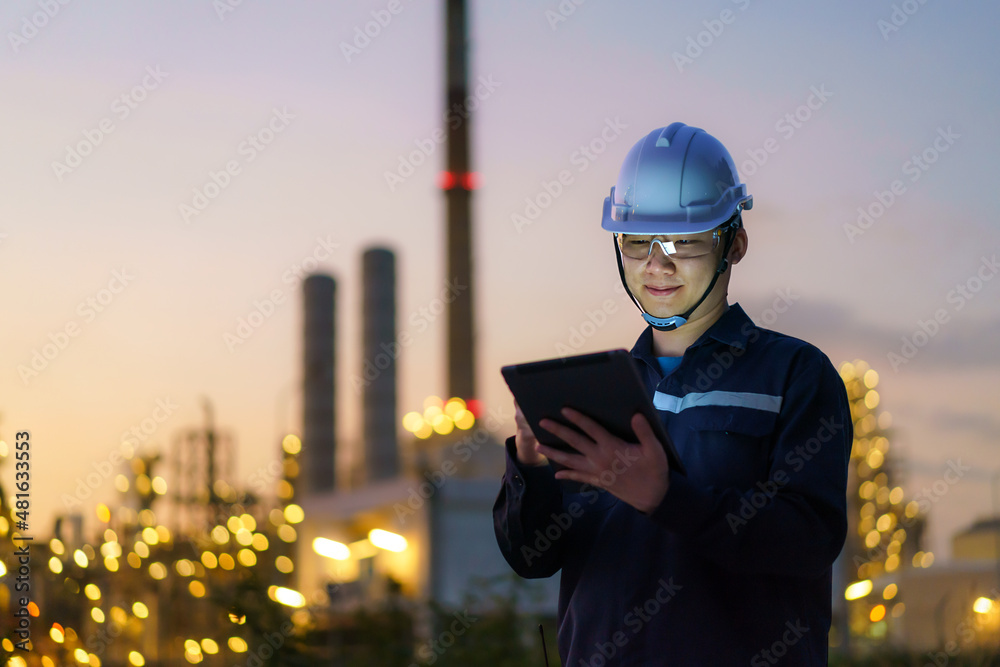 亚洲男子石油化工工程师在石油天然气精炼厂pl内使用数字平板电脑工作