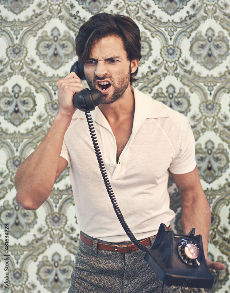 Get it done, NOW. A handsome man in retro 70s clothing shouting at someone on the phone.