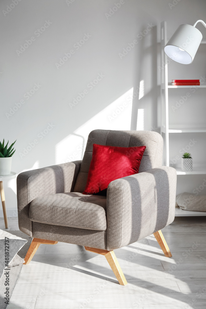 浅色客厅带红色坐垫的软扶手椅