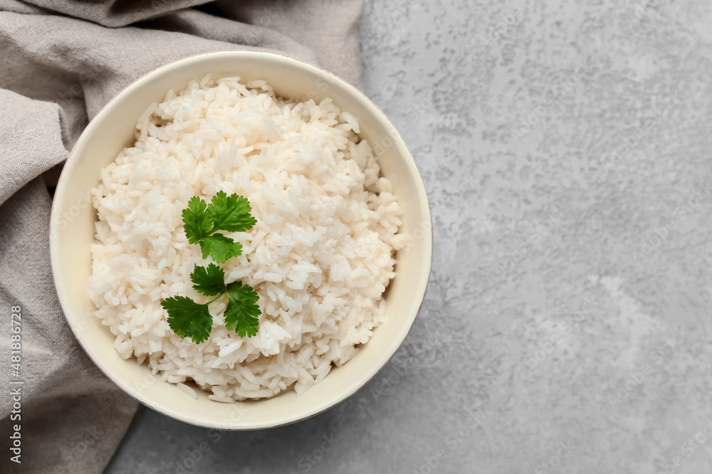 Bowl with tasty boiled rice on grey background, closeup