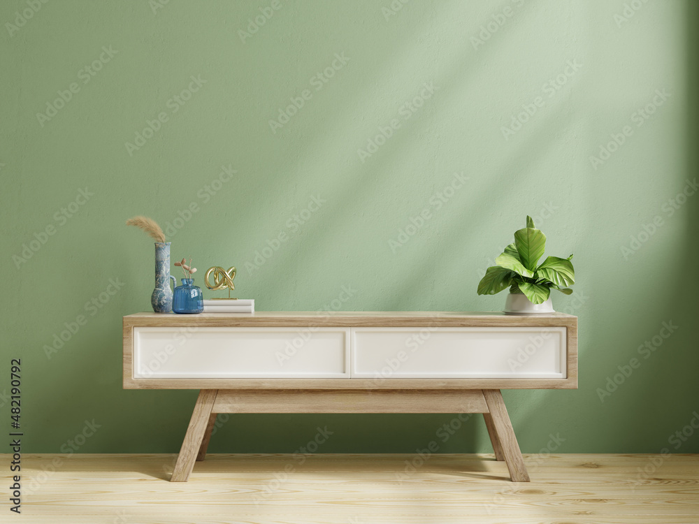 Modern wooden commode for tv mockup in empty room with green wall.