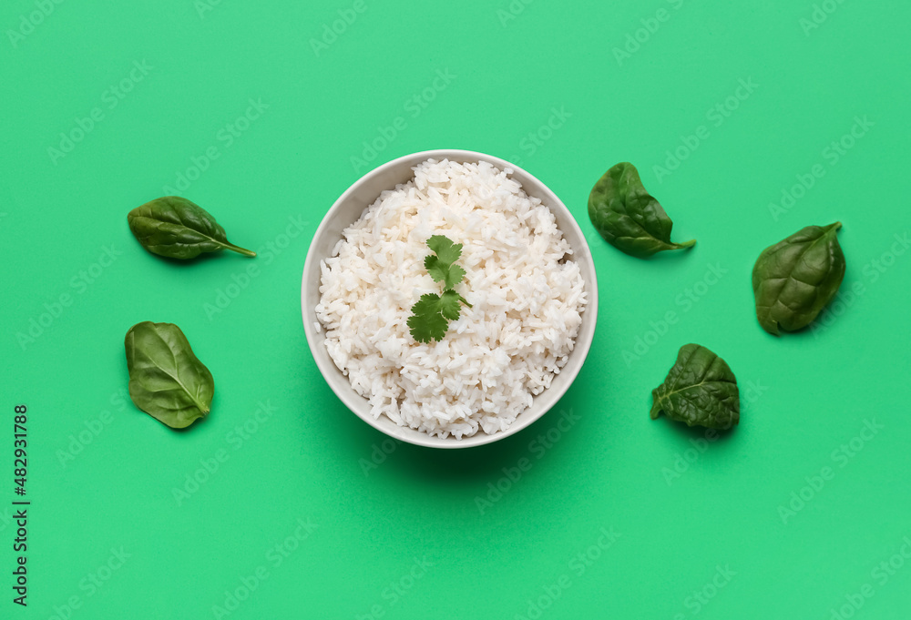 绿色背景下的美味煮米饭和菠菜碗