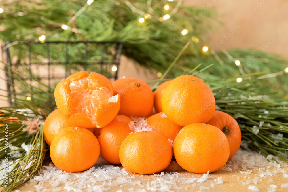 Tasty tangerines and snow on table