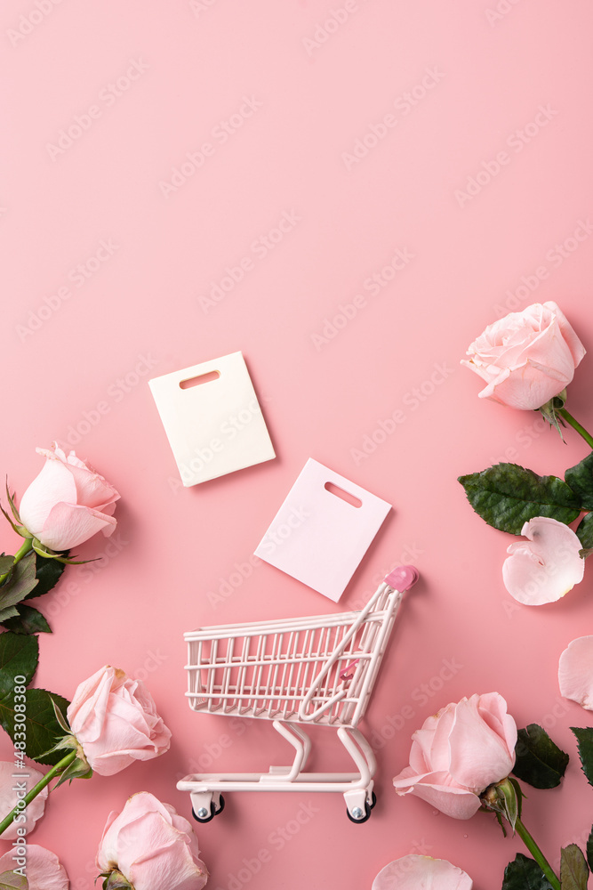 Valentines Day shopping design concept background with pink rose flower and cart on pink background