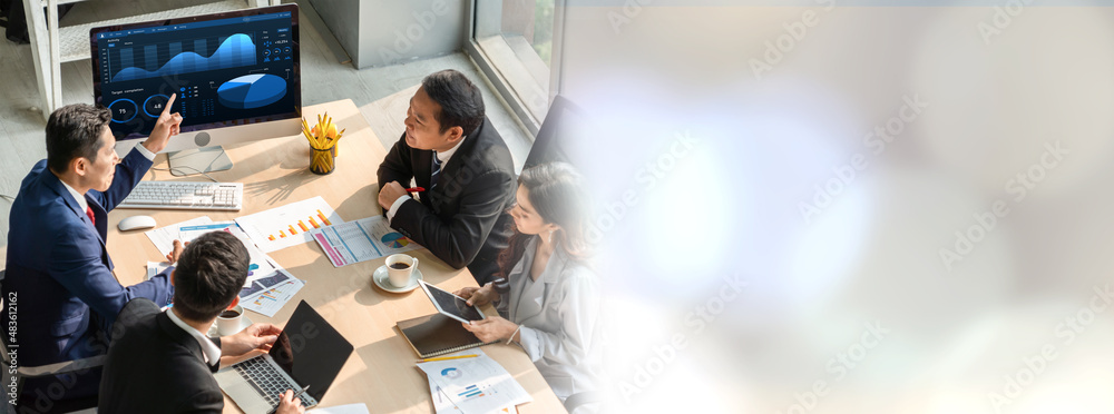 Smart businessman and businesswoman talking discussion in widen group meeting at office table in a m
