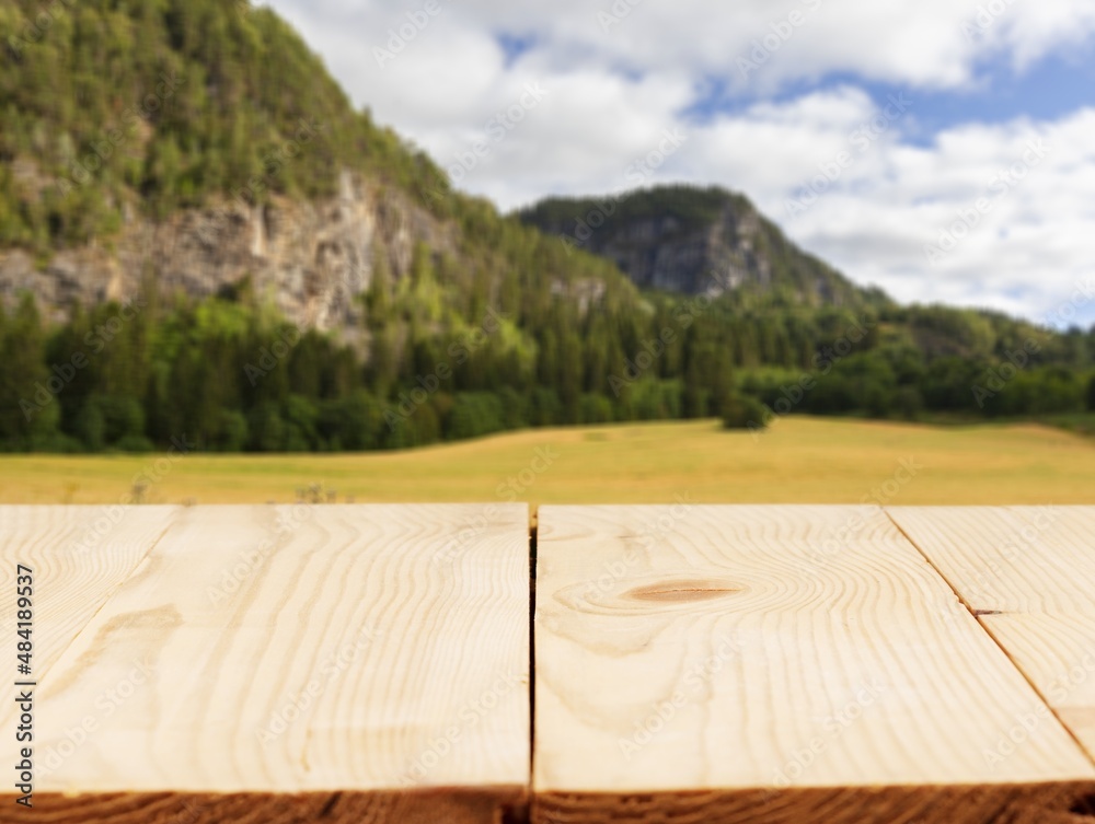 Empty wooden table with Mountain soft blurry background. Use as products display montage.