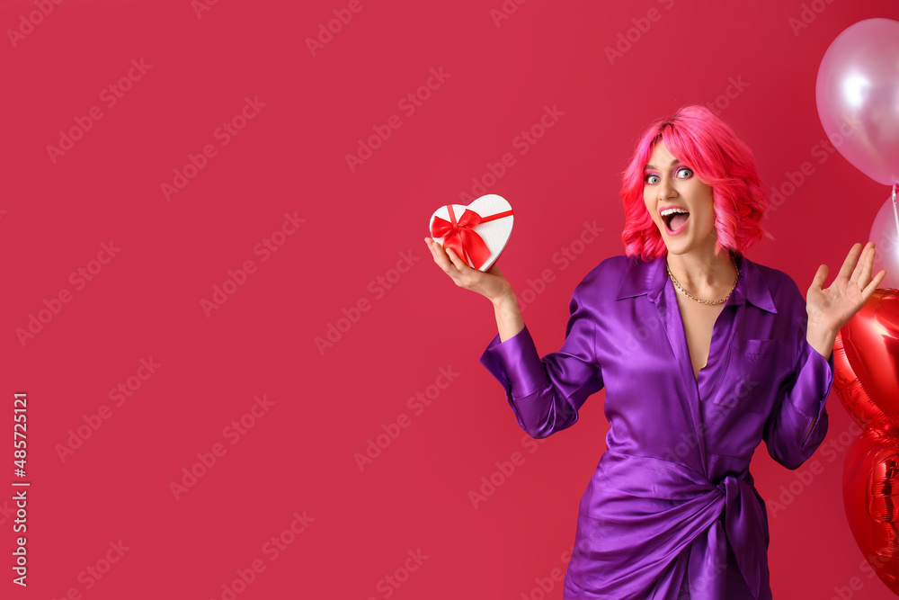 Surprised woman with bright hair, gift and air balloons on color background. Valentines Day celebra
