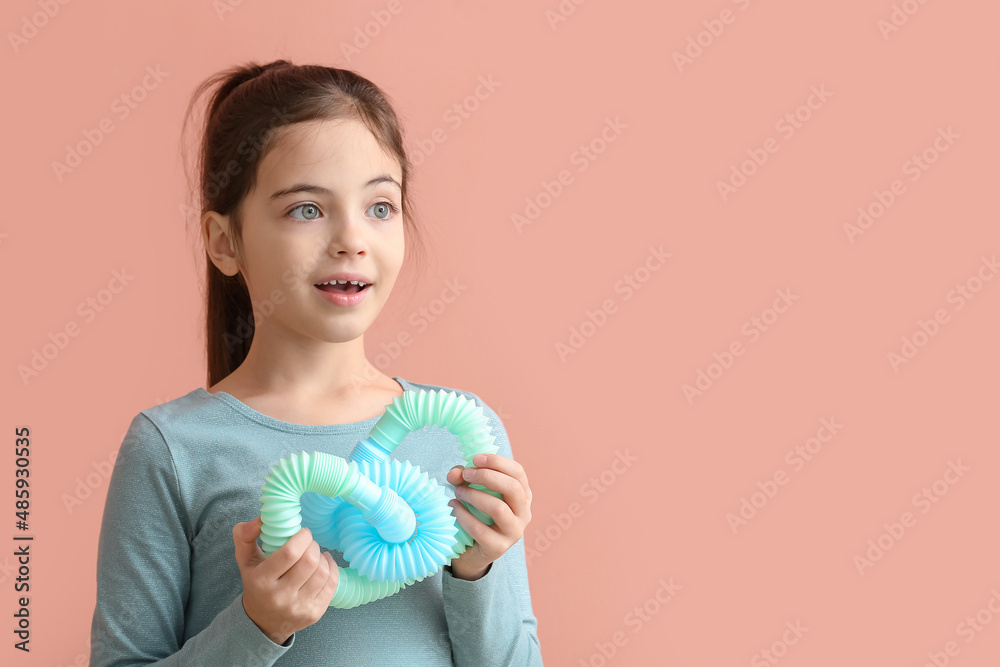 Funny little girl with blue Pop Tubes on pink background