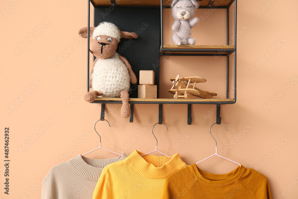 彩色背景上有玩具和毛衣的架子