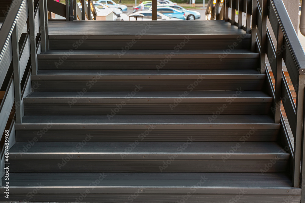 View of modern metal stairs with railing outdoors