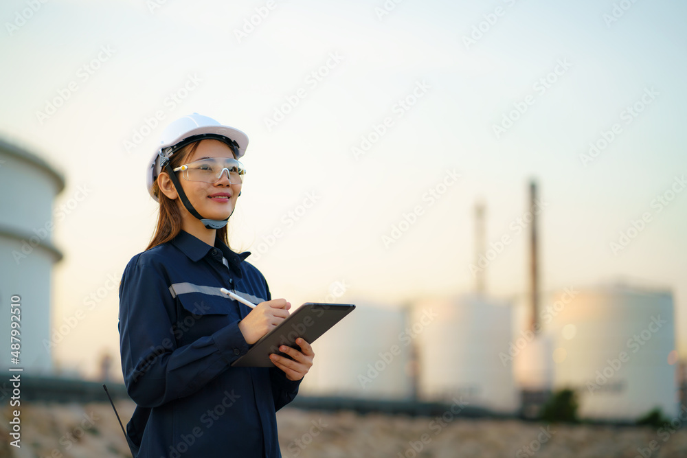 亚洲女石化工程师在石油天然气精炼厂ind内使用数字平板电脑
