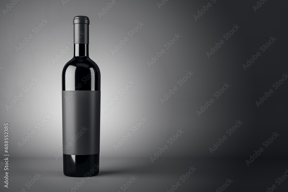 Black wine bottle with empty blank label on abstract dark background with copyspace for your text, r