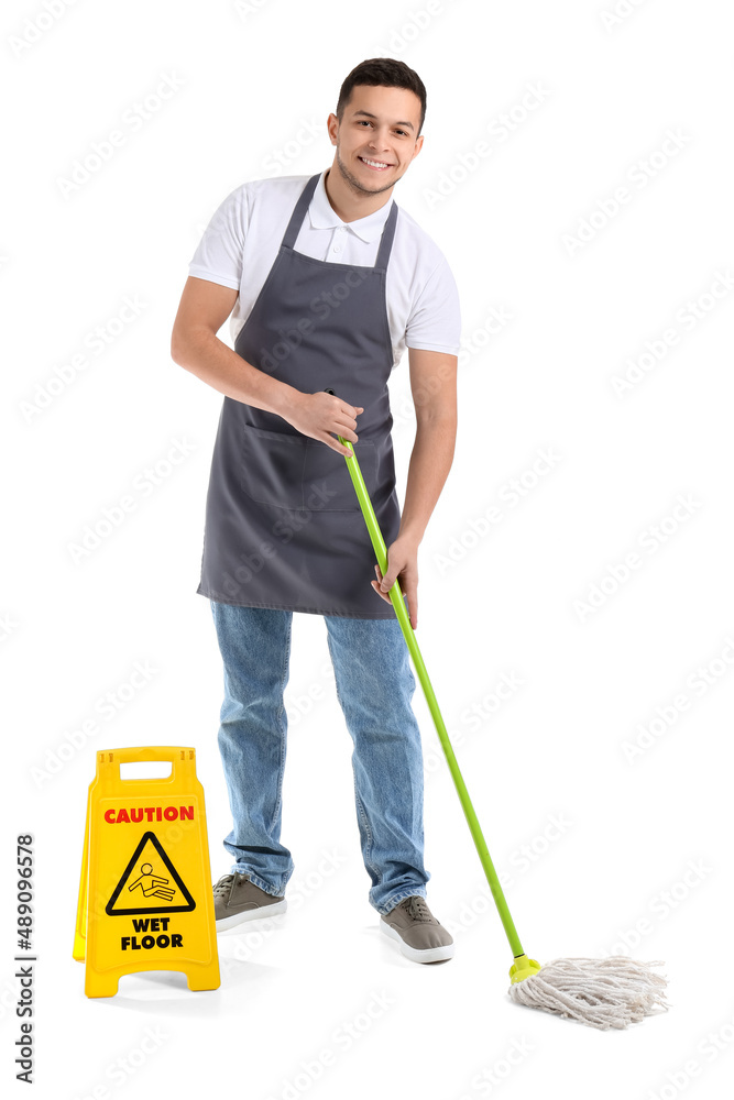 Young male worker of cleaning service with mop and caution sign on white background