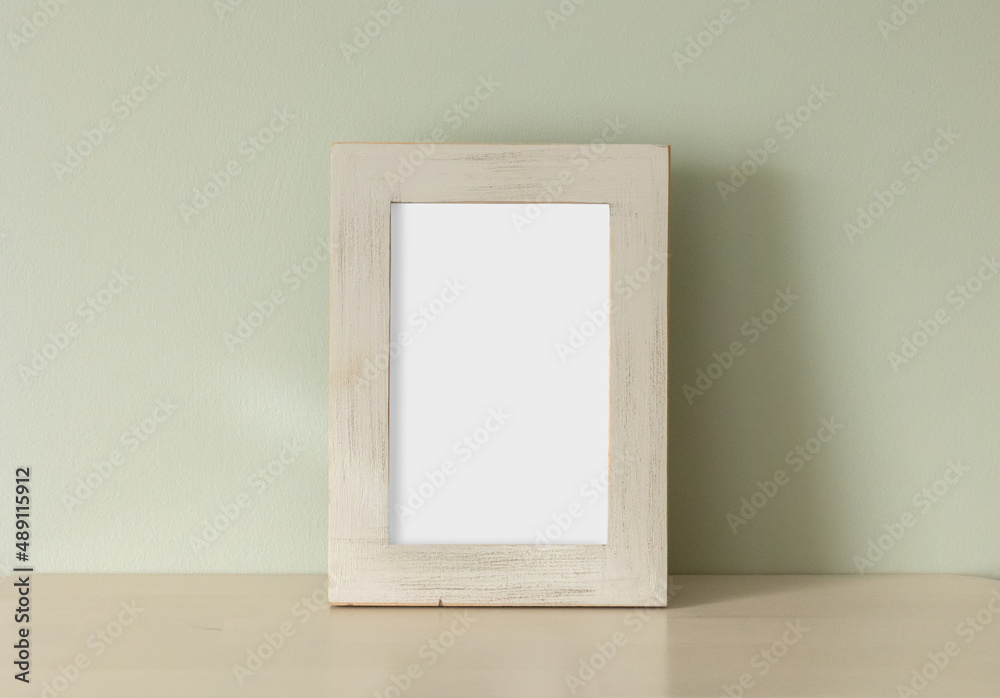 empty frame on green wall background