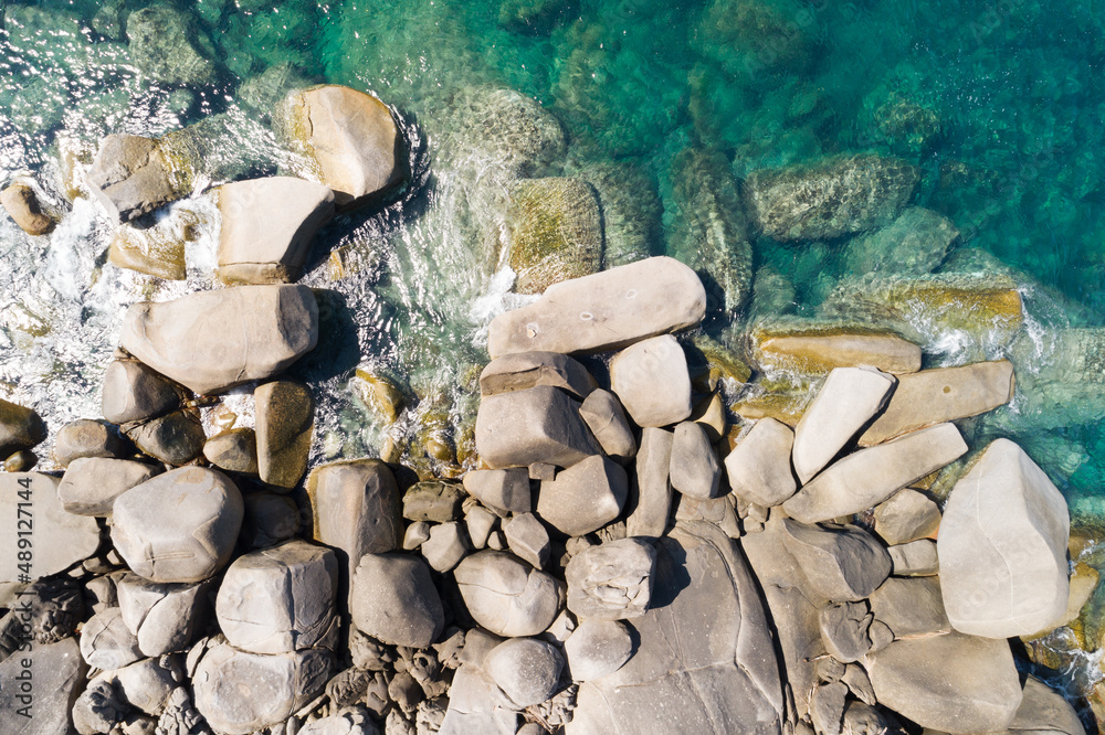 Aerial view Top down seashore rocks sea surface in sunny day Good weather day summer background