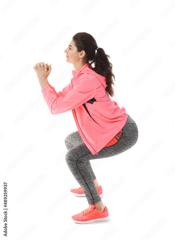 Young sporty woman training on white background