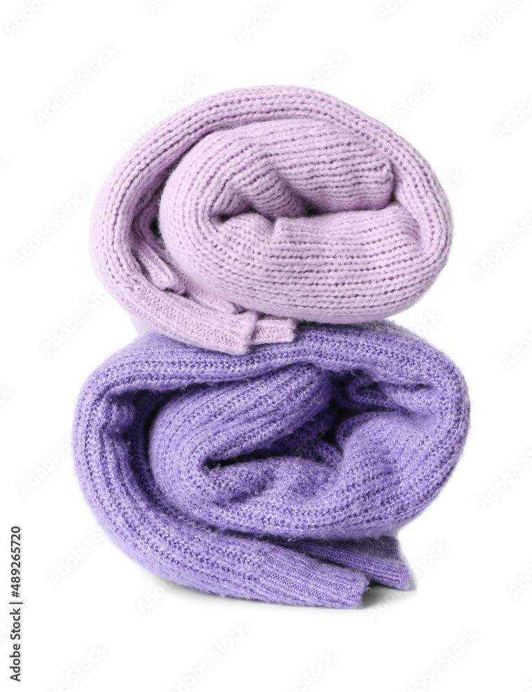 Rolled knitted lilac sweaters on white background