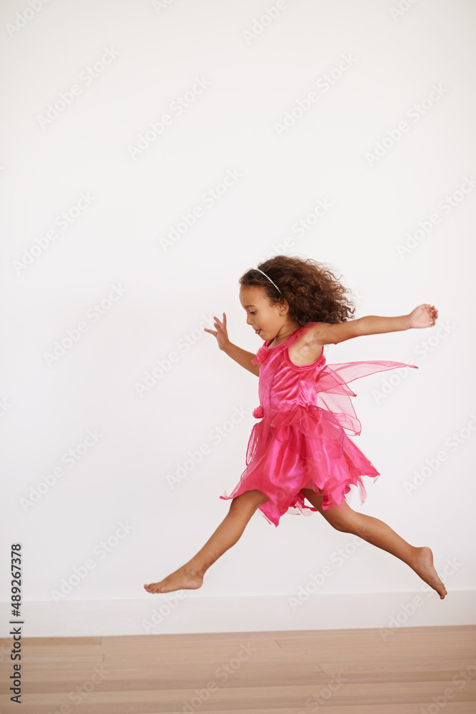 Sugar rush. Cropped shot of an exuberant little girl running indoors.