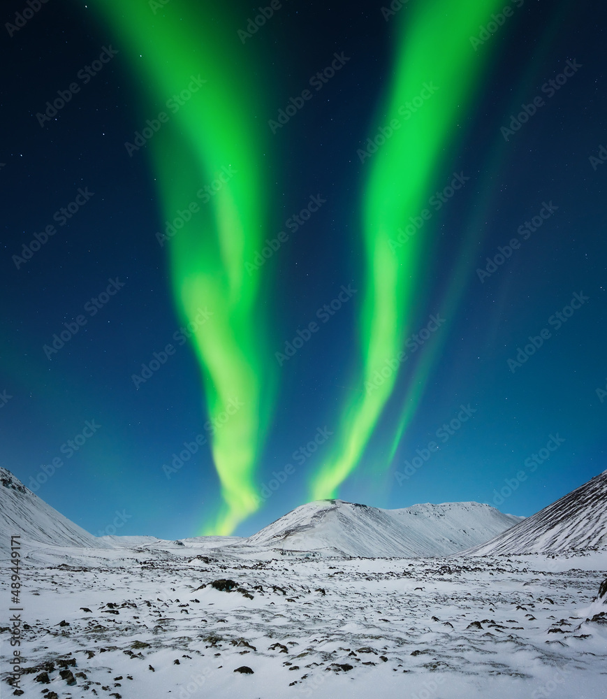 冰岛的北极光。山上的北极光，明亮的冬夜景观
