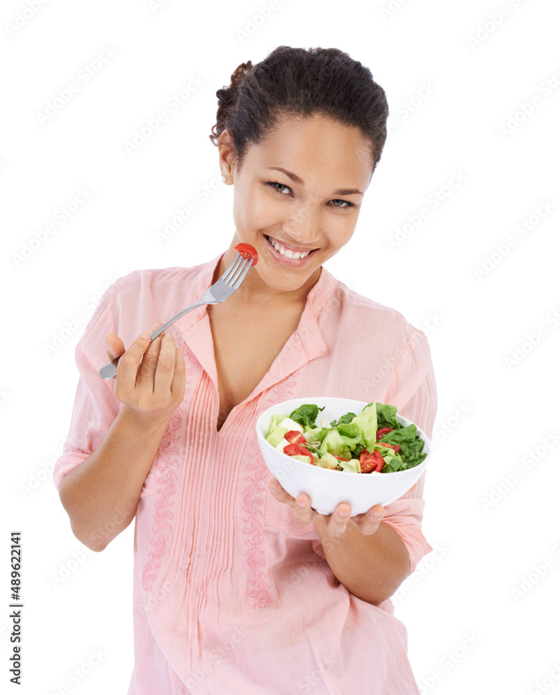Making the healthy choice and having a salad. Young womanl smiling while eating a fresh green salad.