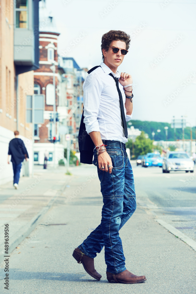 Hes one cool guy. Full length portrait of a fashionably dressed young man out on the street.