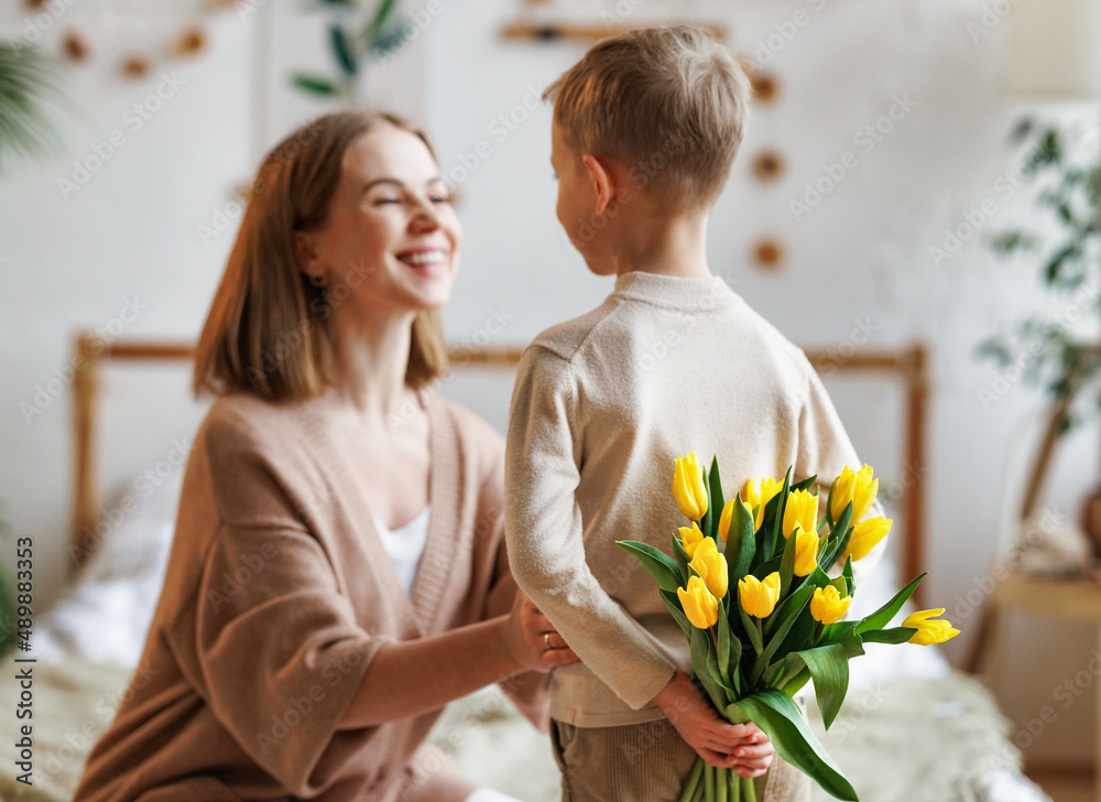 Cheerful mother with bouquet thanks son