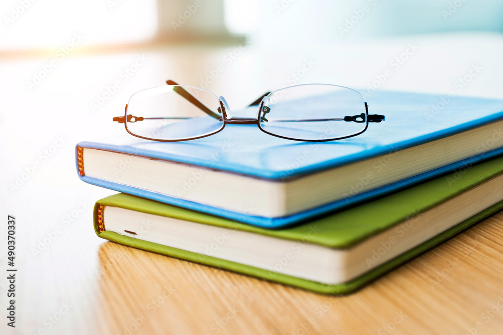 Glasses and books on wooden table