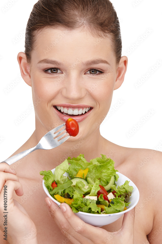 Summer salad days. A teenage girl enjoying a healthy salad.