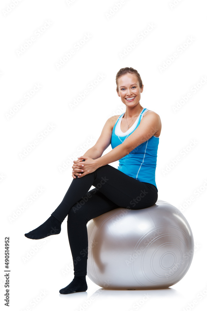 I always feel great after a heavy work out. Portrait of a smiling woman sitting on her exercise ball