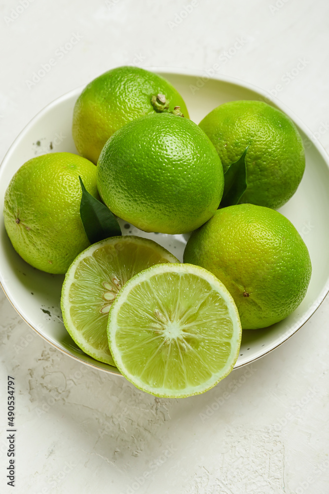 Bowl of ripe bergamot fruits on light background, closeup