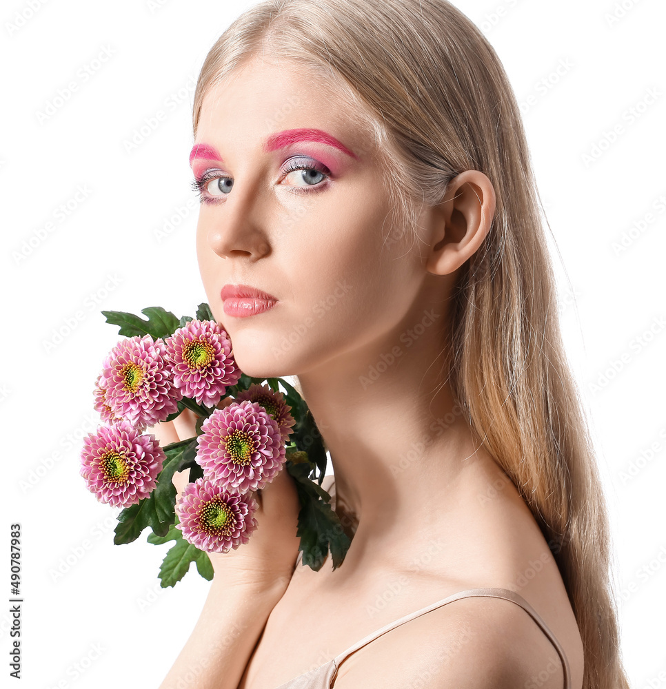 Beautiful woman with creative makeup holding bouquet of flowers on white background