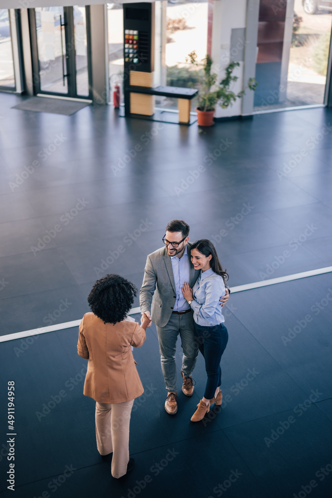 Husband and wife having a quick meeting with one client.
