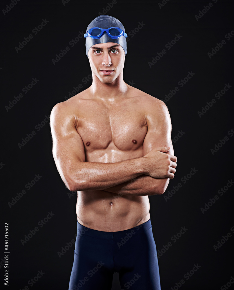 Assured of my pool prowess. Studio portrait of a young male swimmer.