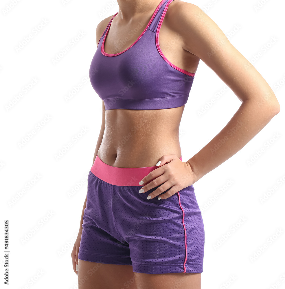 Teenage girl in purple sportswear on white background