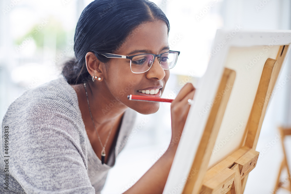 你不一定要优秀才能被认为是一名艺术家。一位年轻漂亮的女性绘画的裁剪镜头