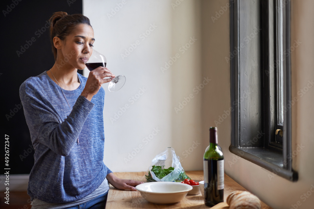 Time for a glass of wine. A young woman drinking wine.