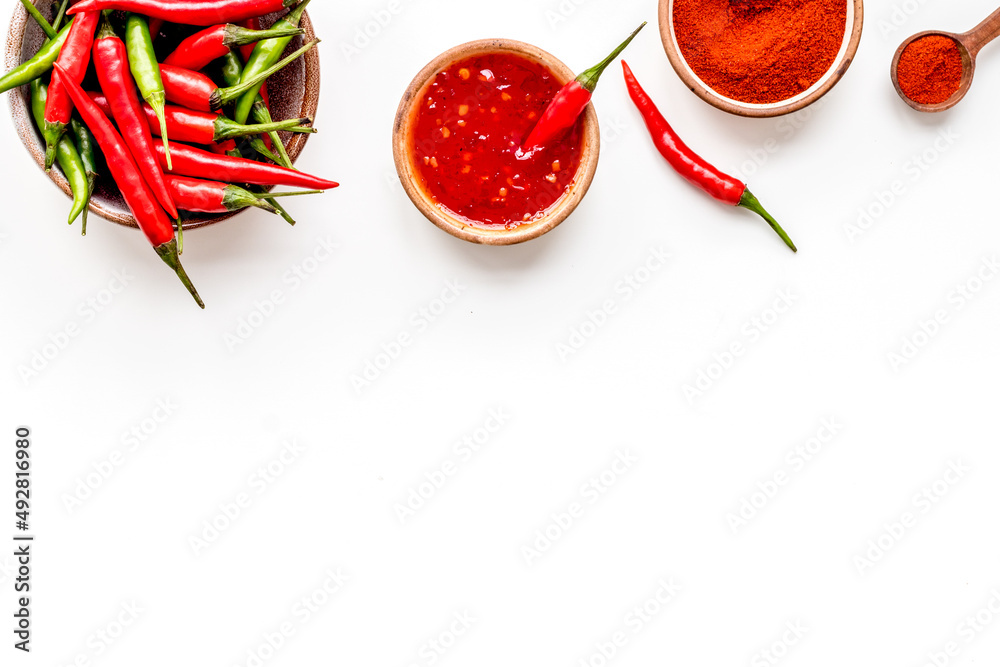 Cooking hot food with chilli pepper on white table background top view copy space