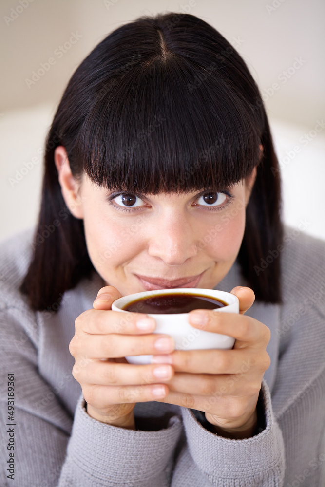 Starting her day with a fresh, strong cup of coffee. Cropped shot of a beautiful young woman enjoyin