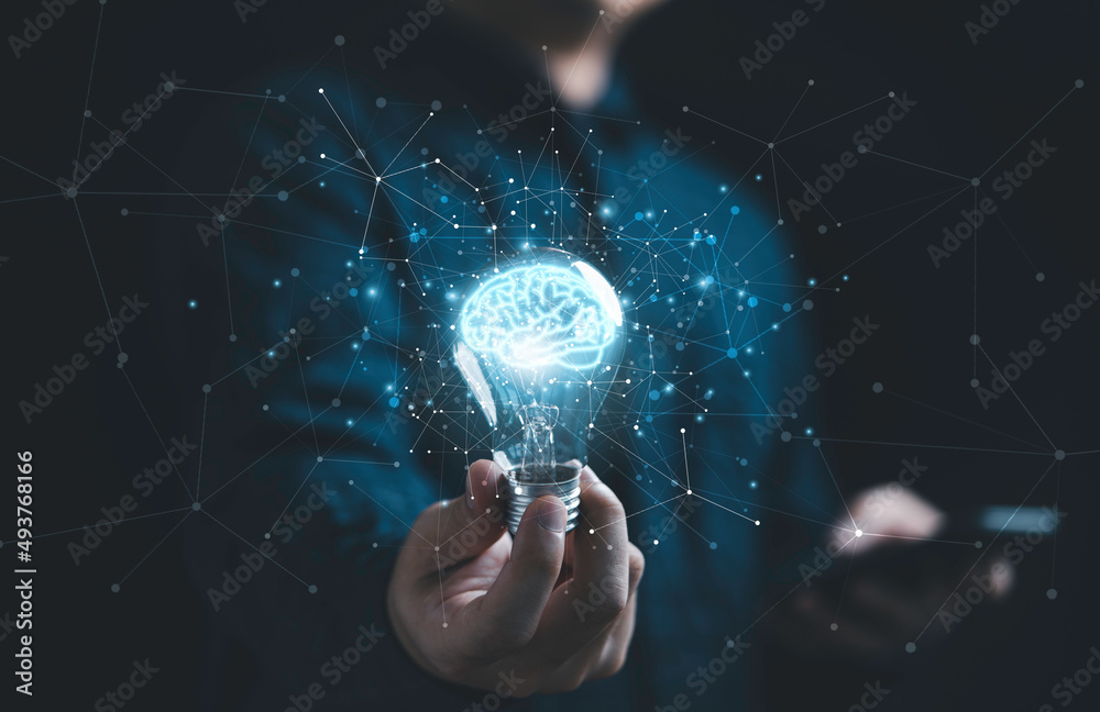 拥有发光虚拟大脑和创意智能连接线的商人手持灯泡