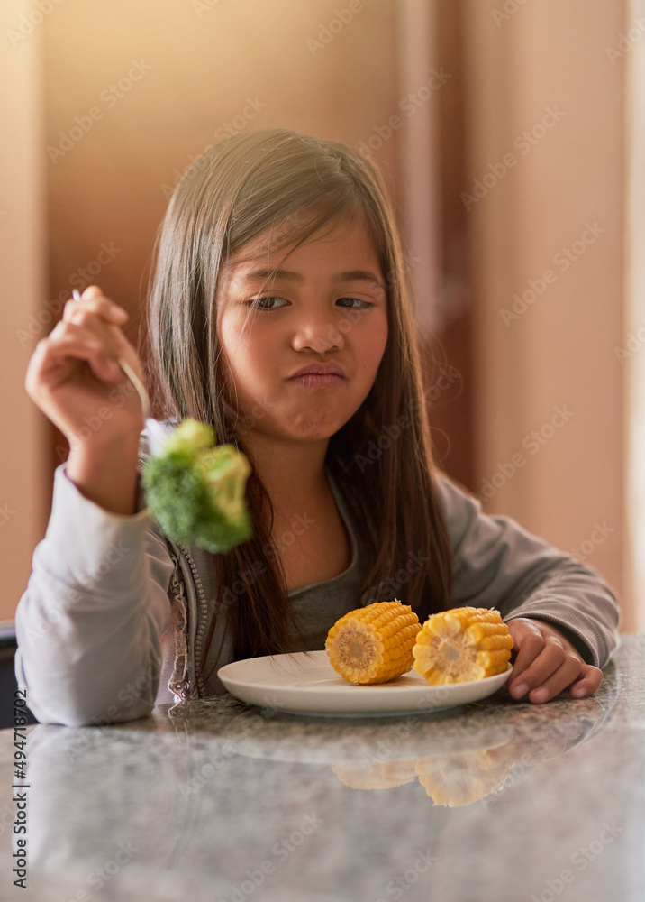Why am I being fed this again. Cropped shot of a little girl refusing to eat her broccoli.