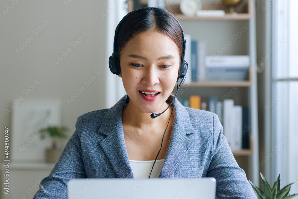 Young Asian businesswoman wearing headphone, call center, customer service talking on video call con