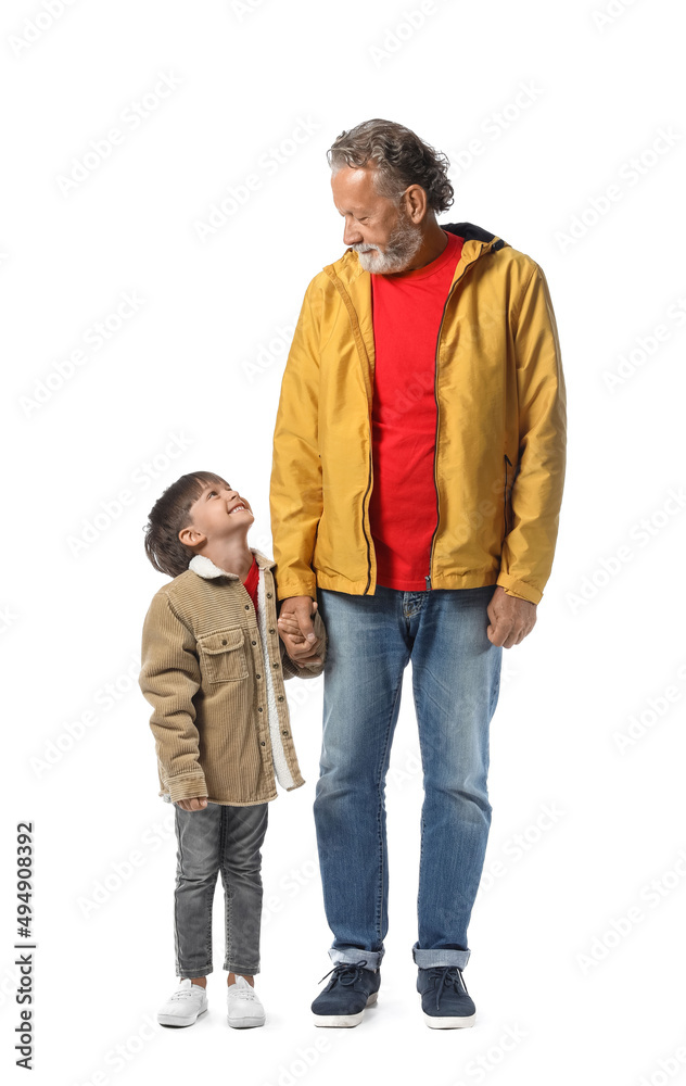 Little boy and his grandfather in warm jackets on white background