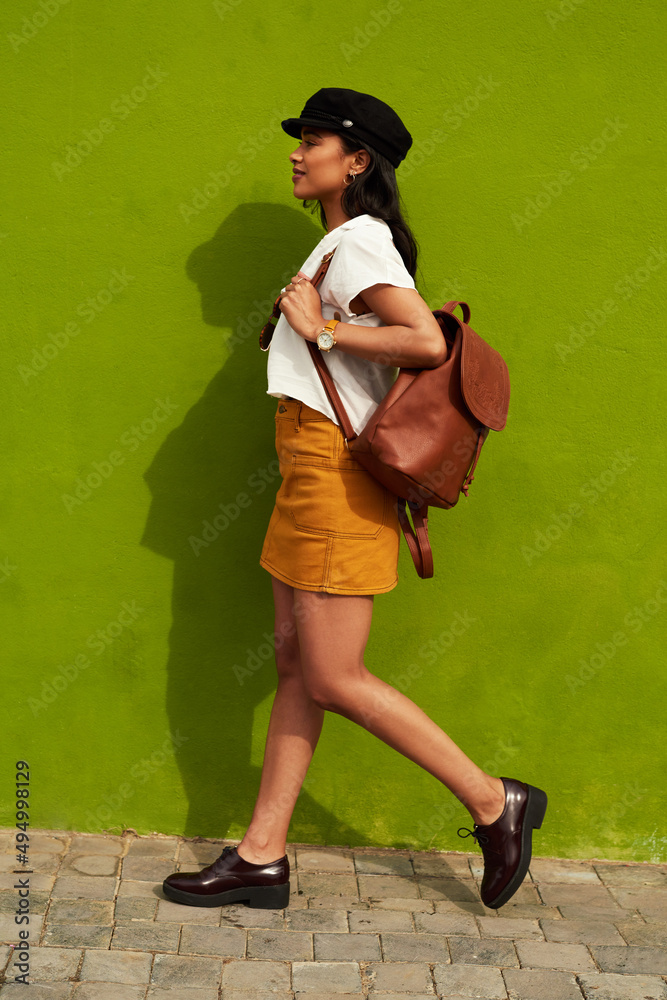 Im a woman on a mission. Full length shot of an attractive young woman walking against a green backg