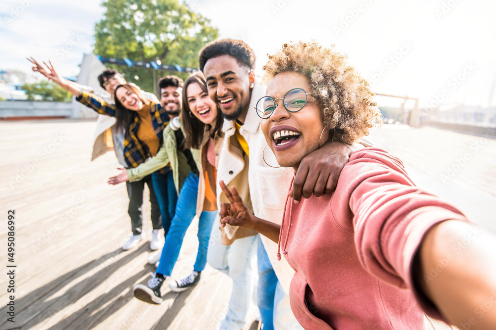 Multiracial friends group taking selfie pic with smartphone outside - Happy young people having fun 