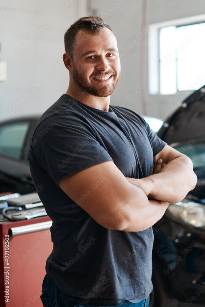 Ill have your car running like new again. Shot of a mechanic posing with his arms crossed in an auto