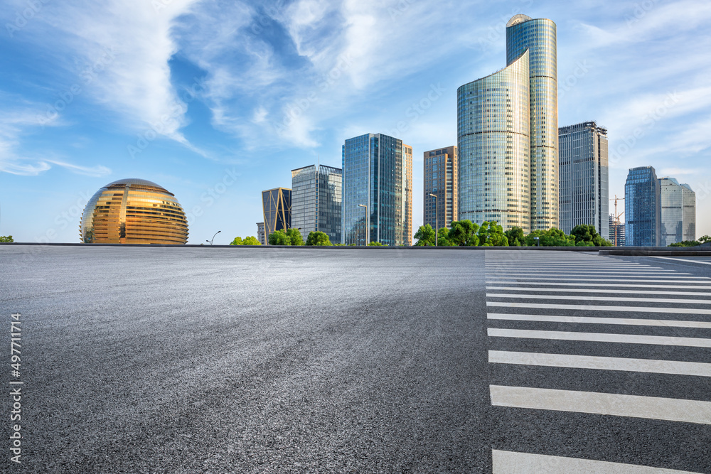 Empty asphalt road and modern city skyline with buildings in Hangzhou, China.